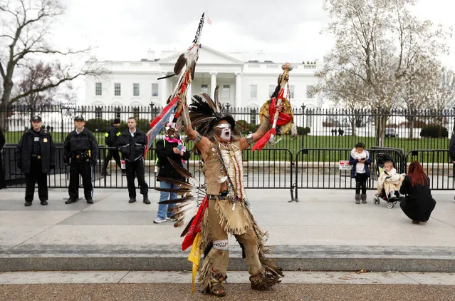 Little Thunder, a traditional dancer and indigenous activist from the Lakota tribe, dances as he demonstrates in front of the White House during a protest march and rally in opposition to the Dakota Access and Keystone XL pipelines in Washington, March 10, 2017. (Photo by Kevin Lamarque/Reuters)