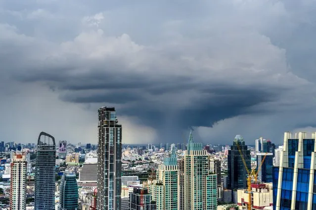 A cumulonimbus cloud is seen over Bangkok's skyline on July 28, 2020. (Photo by Mladen Antonov/AFP Photo)