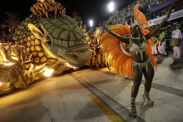 Performers from the Unidos de Vila Isabel samba school parade during Carnival celebrations at the Sambadrome in Rio de Janeiro, Tuesday, February 12, 2013. Rio de Janeiro's samba schools vied for the title of the year's best in an over-the-top, all-night-long Carnival parade at the city's iconic Sambadrome. (Photo by Silvia Izquierdo/AP Photo)