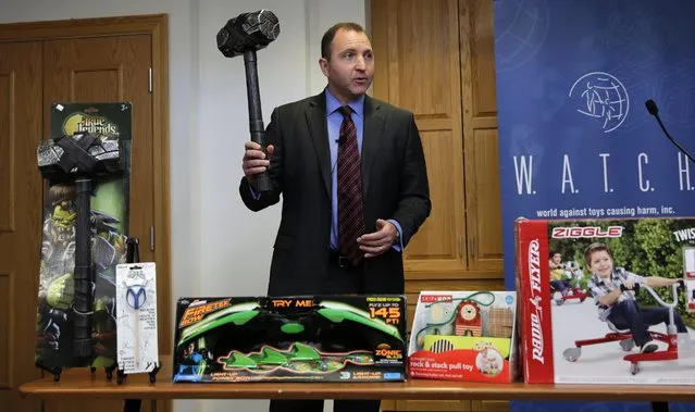 James Swartz, director of World Against Toys Causing Harm Inc., holds up toy battle hammer at Children's Franciscan Hospital in Boston, Wednesday, November 19, 2014. The consumer watchdog group has released its annual list of what it considers to be the 10 most unsafe toys as the holiday season approaches. (Photo by Charles Krupa/AP Photo)