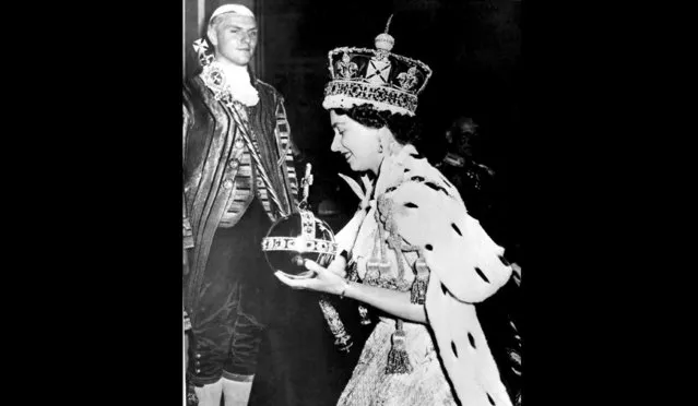 In this June 2, 1953 file photo, Britain's Queen Elizabeth II wearing the bejeweled Imperial Crown and carrying the Orb and Scepter with Cross, leaves Westminster Abbey, London, at the end of her coronation ceremony. Queen Elizabeth II reveals the secrets of giving a speech while wearing a weighty crown, in unusually candid comments that are part of a new documentary to be aired on the BBC on Sunday Jan. 14, 2018, on her coronation and the symbolism of the crown jewels. (Photo by AP Photo)