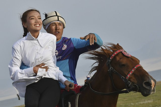 Young participants of The Gallops' 2025 play the national equestrian game Kyz kuar during the competition near the alpine Song-Kol Lake, 280 km, (175 miles) southeast of Bishkek, Kyrgyzstan, Monday, July 21, 2025. (Photo by Vladimir Voronin/AP Photo)