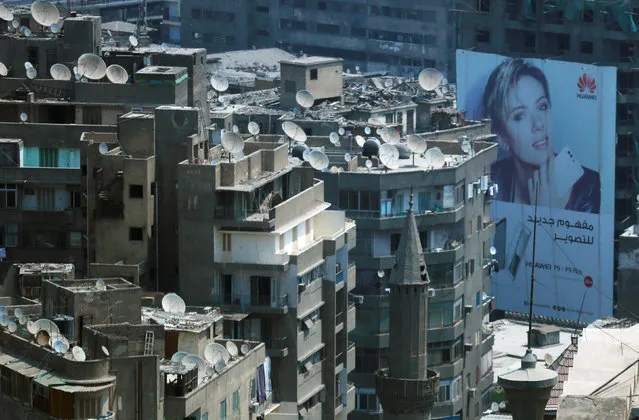 An advertise for Huawei mobile with American actress Scarlett Johansson is seen between old houses at the center of downtown Cairo, Egypt August 31, 2016. (Photo by Amr Abdallah Dalsh/Reuters)