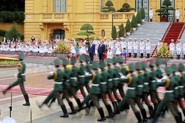 Japanese Prime Minister Yoshihide Suga, center left, and his Vietnamese counterpart Nguyen Xuan Phuc, center right, review an honor guard at the Presidential Palace in Hanoi, Vietnam Monday, October 19, 2020. Suga is on an official visit to Vietnam. (Photo by Minh Hoang/AP Photo/Pool)