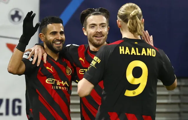 Riyad Mahrez (L) of Manchester City celebrates with teammates Jack Grealish (C) and Erling Haaland after scoring the opening goal during the UEFA Champions League, Round of 16, 1st leg between RB Leipzig and Manchester City in Leipzig, Germany, 22 February 2023. (Photo by Hannibal Hanschke/EPA)