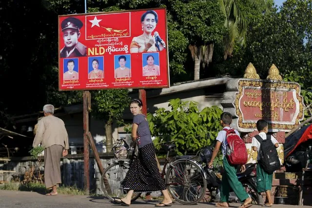 People walk past a campaign billboard of Aung San Suu Kyi's NLD party in Yangon November 4, 2015. Myanmar on November 8 is holding its first free and fair election in 25 years in which democracy icon Aung San Suu Kyi is pitted against the ruling party comprised of former members of a military junta. (Photo by Jorge Silva/Reuters)