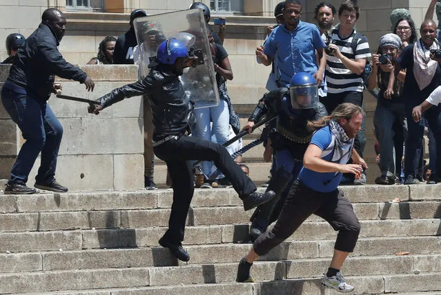 A riot police officer and private security guards attempt to detain a student as they clashed during  protests with students demanding free education on Monday at the Johannesburg's University of the Witwatersrand, South Africa, October 10,2016. (Photo by Siphiwe Sibeko/Reuters)