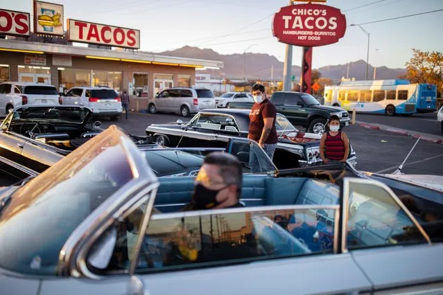 A man parks his low rider car as two boys look on outside one of the city's most popular restaurants amid the coronavirus disease (COVID-19) outbreak, in El Paso, Texas, U.S. November 15, 2020. (Photo by Ivan Pierre Aguirre/Reuters)