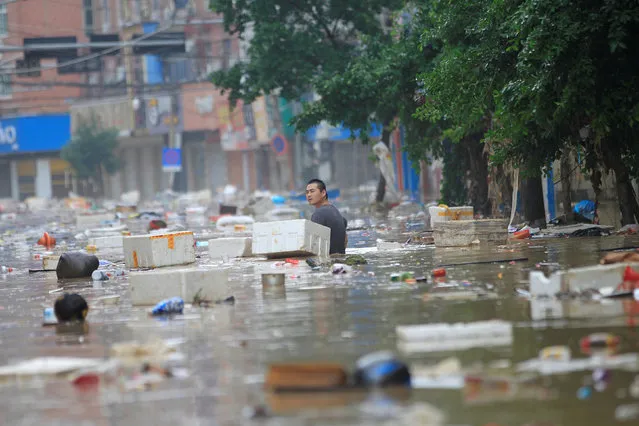 A man wades through a flooded street in Wenzhou, Zhejiang province, China, September 29, 2016. (Photo by Reuters/Stringer)