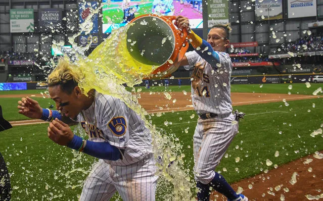 Milwaukee Brewers shortstop Orlando Arcia (3) gets dunked by left fielder Hernan Perez (14) after bringing in the game winning run with an RBI single in the ninth inning against the Chicago Cubs at Miller Park in Milwaukee, WI, USA on April 6, 2018. (Photo by Benny Sieu/Reuters/USA TODAY Sports)