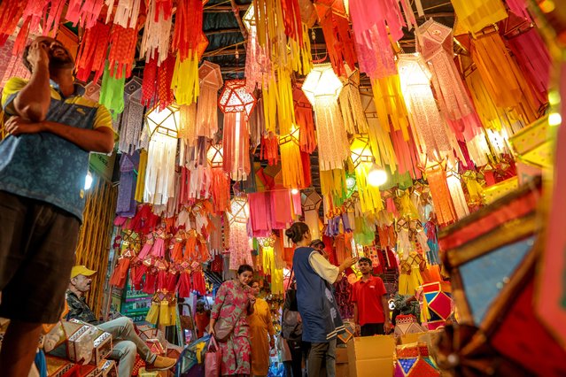 People browse colorful lanterns for sale at a local market ahead of the Diwali festival in Mumbai, India, 14 October 2025. The Hindu Festival of Lights, or Diwali, symbolizes the victory of good over evil, light over darkness, and marks Lord Rama's return to his kingdom, Ayodhya, after completing a 14-year exile. The main day of Diwali will be celebrated on 20 October this year. (Photo by Divyakant Solanki/EPA)