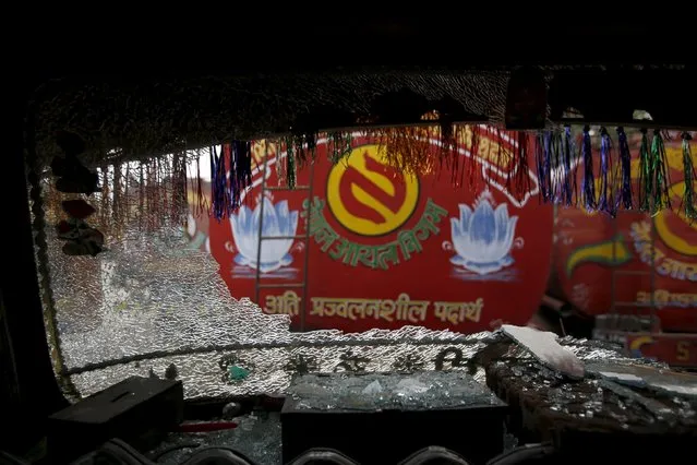A vandalised windshield is pictured on a petrol tanker parked at customs at the Nepalese-Indian border during general strike called by Madhesi protesters demonstrating against the new constitution in Birgunj, Nepal November 5, 2015. (Photo by Navesh Chitrakar/Reuters)
