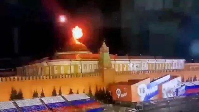 A still image taken from video shows a flying object exploding in an intense burst of light near the dome of the Kremlin Senate building during the alleged Ukrainian drone attack in Moscow, Russia on May 3, 2023. (Photo by Ostorozhno Novosti via Reuters)