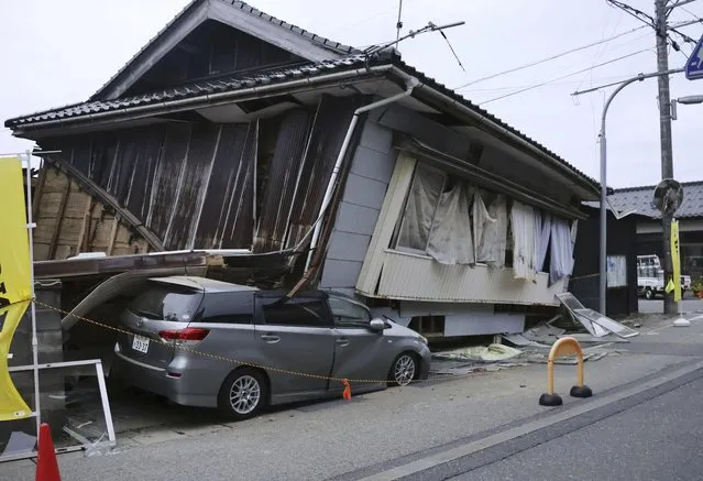 A car is seen crushed by a collapsed house after a strong earthquake in Suzu city, Ishikawa prefecture, northern Japan, Friday, May 5, 2023. A strong earthquake hit Friday afternoon near central Japan, but there were no reports of a tsunami threat.(Photo by Kyodo News via AP Photo)