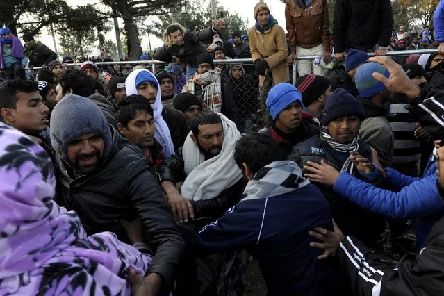 Stranded migrants try to storm the Greek-Macedonian border, near the village of Idomeni, Greece  December 2, 2015. (Photo by Alexandros Avramidis/Reuters)