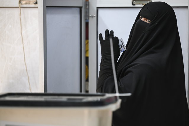A woman casts her ballot papers at a polling station during the first round of parliamentary elections in Giza, Egypt, 10 November 2025. Egypt's first round of parliamentary elections are scheduled for 10 and 11 November. (Photo by Mohamed Hossam/EPA)