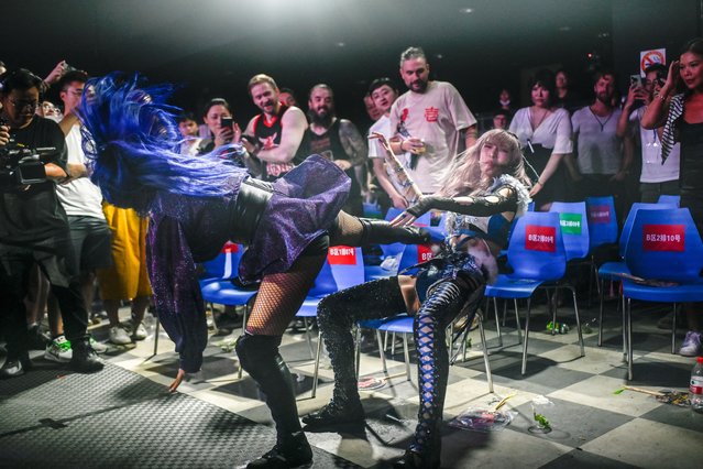 This picture taken on September 14, 2024 shows Japanese wrestler Yuki Kamifuku (R) fighting her opponent “Crystal” of the Philippines during a Middle Kingdom Wrestling (MKW) championship event in Shanghai. Despite a promising potential domestic market, the Chinese pro wrestling community has been battling for recognition and financial stability for decades. (Photo by Wang Zhao/AFP Photo)