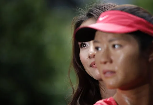 Current Australian Open tennis women's champion China's Li Na stands next to her Madame Tussauds wax figure after it was unveiled at Melbourne Park January 18, 2015. (Photo by Carlos Barria/Reuters)