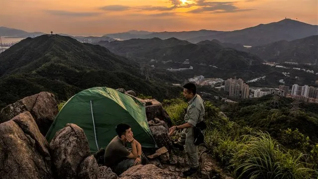 Police stand guard on top of Lion Rock mountain in anticipation of people gathering to mark the fourth anniversary of the city's mass protests in Hong Kong, Monday, June 12, 2023. (Photo by Louise Delmotte/AP Photo)