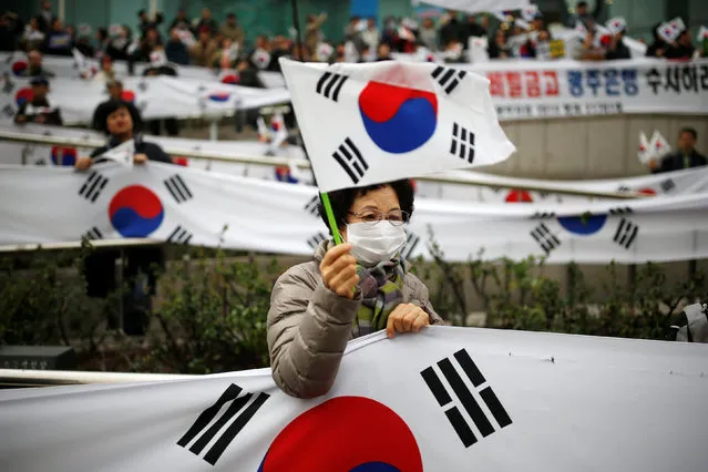 A supporter of South Korean President Park Geun-hye takes part in a rally opposing calls for her resignation, in Seoul, South Korea, November 19, 2016. (Photo by Kim Hong-Ji/Reuters)