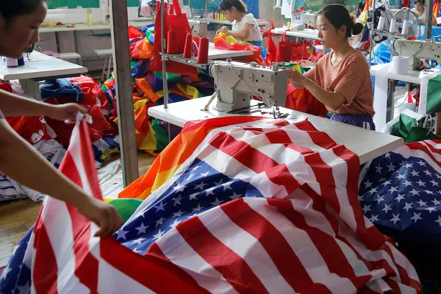 A worker makes U.S. national flags at Jiahao flag factory in Fuyang, Anhui province, China July 24, 2018. Picture taken July 24, 2018. (Photo by Aly Song/Reuters)