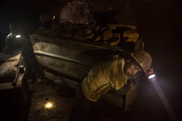 Miners move an ore wagon of silver deep inside Bolivia’s Cerro Rico silver mines. The work here is incredibly dangerous. And even today deaths are common. (Photo by Hugh Brown/South West News Service)