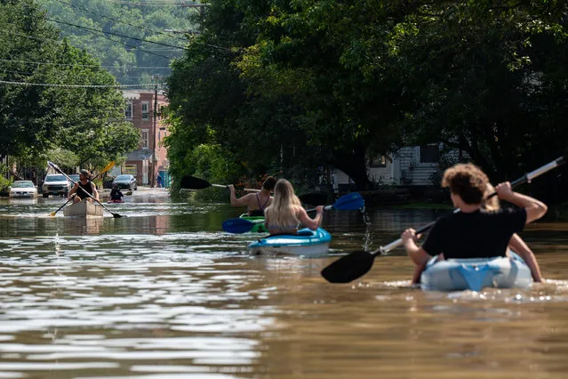 People kayak up and down the flooded waters of Elm Street on July 11, 2023 in Montpelier, Vermont. Up to eight inches of rain fell over 48 hours and residents were warned that Wrightsville Dam could reach capacity, forcing it to release more water that could impact the downtown area. (Photo by Kylie Cooper/Getty Images)