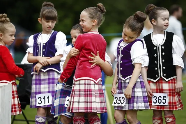 Dancers wait to compete during the Inveraray Highland Games on July 18, 2023 in Inveraray, Scotland. The games are held annually in the grounds of Inveraray Castle. They celebrate Scottish culture and heritage with field and track events, piping, highland dancing competitions and heavy events including the world championships for tossing the caber. (Photo by Jeff J. Mitchell/Getty Images)