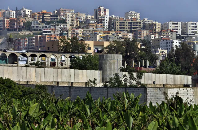 In this Friday, May 5, 2017 photo, a general view of the concrete wall surrounding the Ein el-Hilweh Palestinian refugee camp near the southern port city of Sidon, Lebanon. (Photo by Bilal Hussein/AP Photo)
