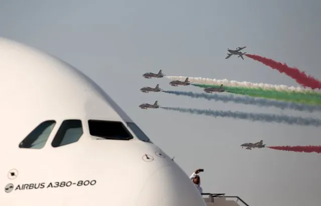 A man standing on an Air Bus A380 takes a picture with his phone as United Arab Emirates's Al Fursan perform their stunts during the first day of the Bahrain Air Show 2016 at Sakhir south of Bahrain January 21, 2016. (Photo by Hamad I Mohammed/Reuters)