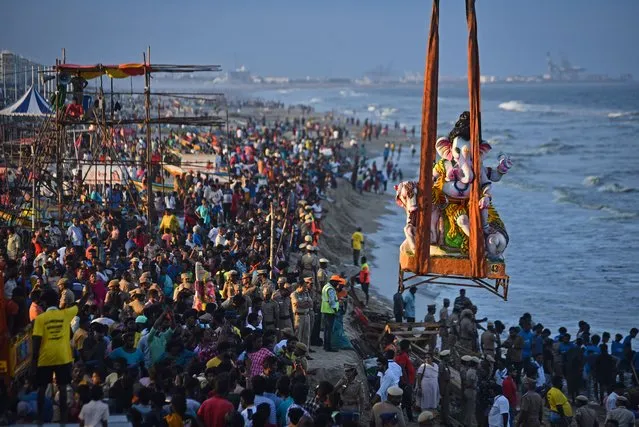 Hindu devotees gather for the immersion of the idols of elephant-headed Hindu god Lord Ganesh during the Ganesh Chaturthi festival, at Pattinapakkam beach, in Chennai, India, 24 September 2023. The ten-day-long Hindu festival marks the birth of Lord Ganesha. Idols of the Hindu deity are worshiped at hundreds of pandals or makeshift tents before they are immersed into water bodies. (Photo by Idrees Mohammed/EPA)