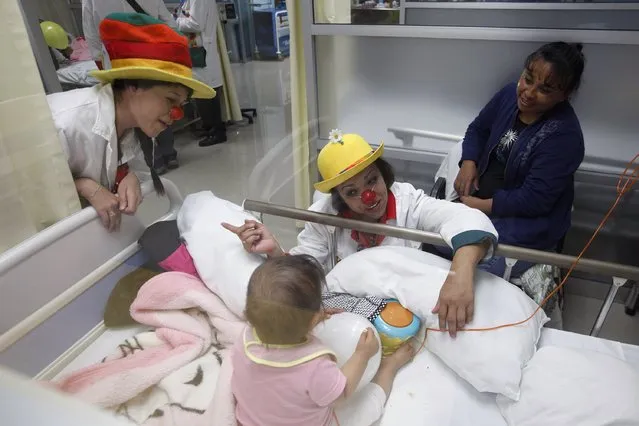 Members of “Laughter Doctors of Ciudad Juarez” perform at a children's hospital in Ciudad Juarez March 11, 2015. (Photo by Jose Luis Gonzalez/Reuters)