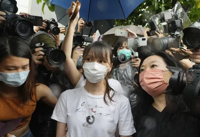 Agnes Chow, center, a prominent pro-democracy activist who was sentenced to jail last year for her role in an unauthorized protest, is released in Hong Kong Saturday, June 12, 2021. Chow rose to prominence as a student leader in the now defunct Scholarism and Demosisto political groups, alongside other outspoken activists such as Joshua Wong and Ivan Lam. (Photo by Vincent Yu/AP Photo)