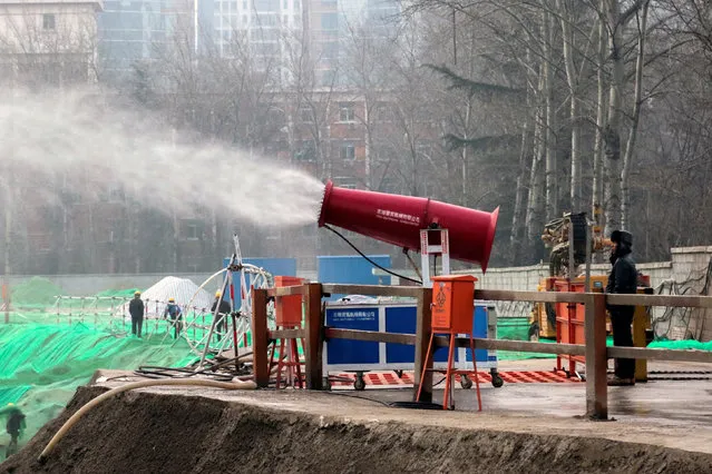 A machine is used to reduce pollution at a construction side during a polluted day in Beijing, China, December 18, 2016. (Photo by Reuters/Stringer)