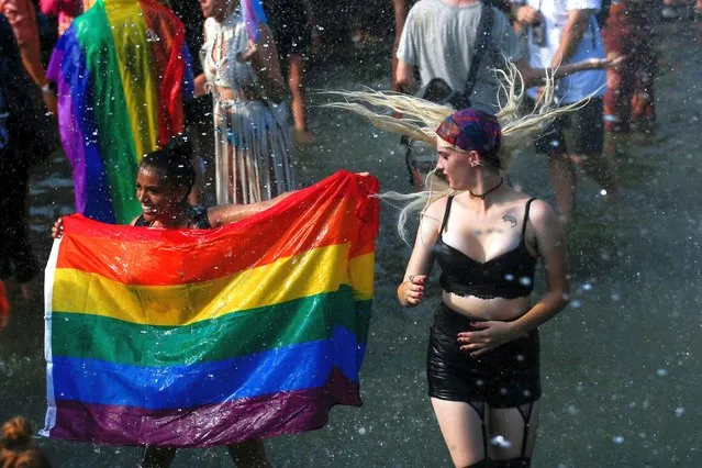 People celebrate as they arrive to Washington Square park during the Queer Liberation March in New York City, New York, U.S., June 27, 2021. (Photo by Eduardo Munoz/Reuters)