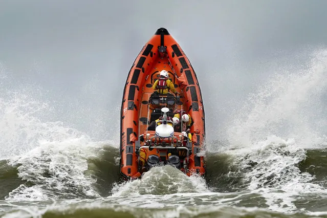 An RNLI Lifeboat crashes through waves during a multi-agency exercise to test emergency response, at Camber Sands, East Sussex, England, Thursday, September 28, 2023. The multi-agency exercise, organised by South East Coast Ambulance Service, (SECAmb) also includes Sussex Police, East Sussex Fire and Rescue Service, Rother District Council, HM Coastguard and RNLI Lifeguards. (Photo by Gareth Fuller/PA Wire via AP Photo)