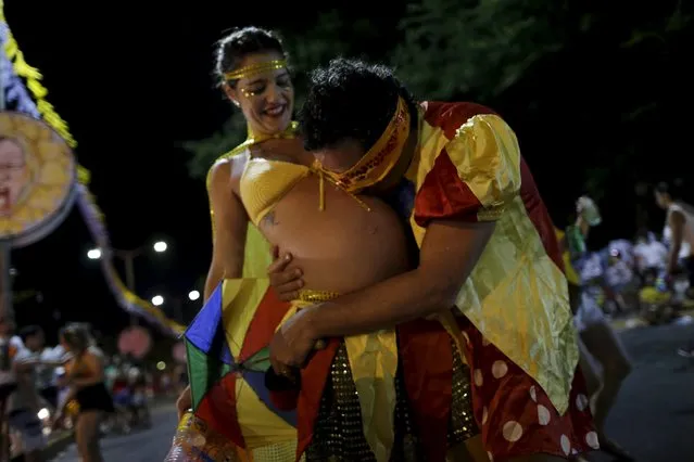 Henrique kisses his wife Paula, who is seven months pregnant, during an annual block party known as “Eu Acho e pouco” (I think it is little) one of the many carnival parties to take place in the neighbourhoods of Olinda, Brazil February 6, 2016. (Photo by Ueslei Marcelino/Reuters)