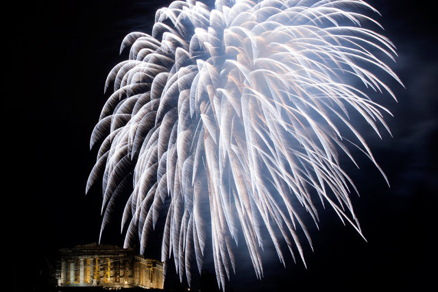 Fireworks explode over the ancient Parthenon temple atop Acropolis hill during New Year's day celebrations in Athens, Greece, January 1, 2017. (Photo by Alkis Konstantinidis/Reuters)
