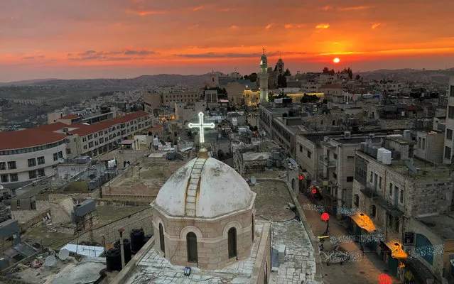 A view shows the dome of the Assyrian church facing a mosque minaret at Manger Square where the Church of the Nativity is located, in Bethlehem in the Israeli-occupied West Bank on December 24, 2018. (Photo by Mustafa Ganeyeh/Reuters)