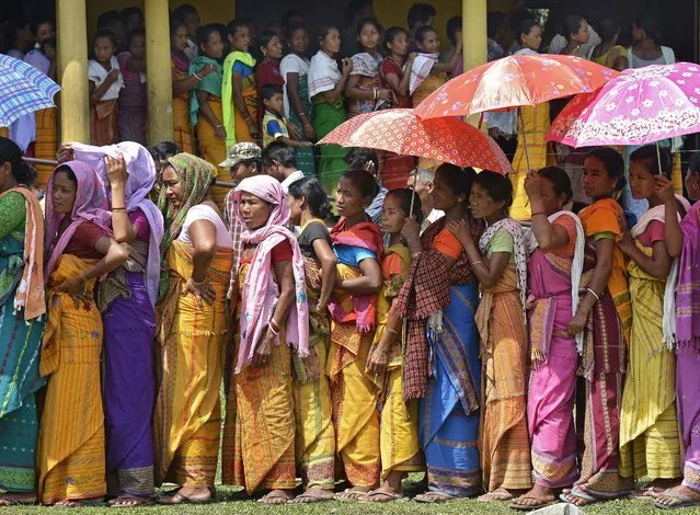 Bodo tribal people wait in queue to cast their votes during the 3rd Bodoland Territorial Area District (BTAD) elections in Baksa district of Assam state, India, 08 April 2015. Thousands of people are eligible to vote in 2,778 polling stations in the four BTAD districts of Assam. A total of 315 candidates are contesting in the 40 constituencies spread over four districts of BTAD. (Photo by EPA/Stringer)