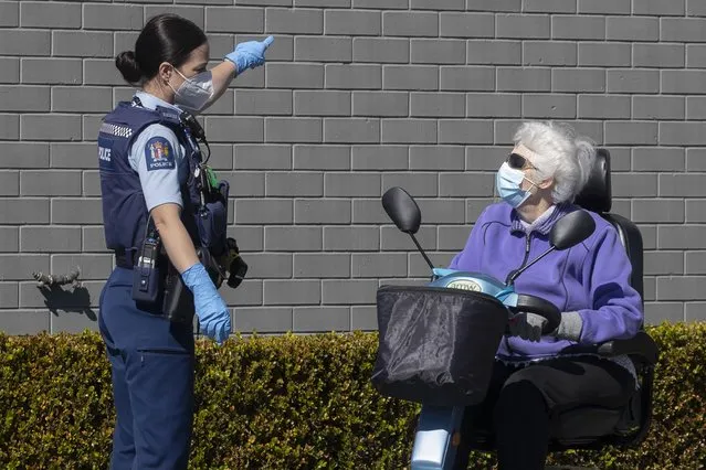 A police officer gestures to a customer to leave outside a supermarket in Auckland, New Zealand, Saturday, September 4, 2021.New Zealand authorities say they shot and killed a violent extremist, Friday Sept. 3, after he entered the supermarket and stabbed and injured six shoppers. Prime Minister Jacinda Ardern described Friday's incident as a terror attack. (Photo by Brett Phibbs/AP Photo)