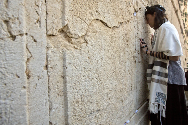 In this photo taken Thursday, February 25, 2016, Reform Rabbi Nicole Greninger prays with other American and Israeli Reform rabbis in the Western Wall, the holiest site where Jews can pray in Jerusalem's old city, A recent gathering of American Reform rabbis in Jerusalem was meant to celebrate the small gains the liberal Jewish movement has made in Israel in recent years. (Photo by Sebastian Scheiner/AP Photo)