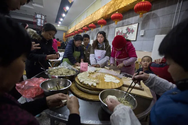 Villagers gather to make dumplings ahead of the lunar Chinese new year at a village on the outskirts of Beijing, China, Thursday, January 26, 2017. (Photo by Ng Han Guan/AP Photo)