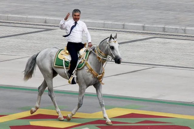 Turkmenistan's President Gurbanguly Berdymukhamedov rides a horse while celebrating the country's 30th independence anniversary in Ashgabat, Turkmenistan, Monday, September 27, 2021. Turkmenistan on Monday marked the 30th anniversary of its independence with a military parade that involved thousands of people. The pomp-filled parade took place in Ashgabat, the capital of the gas-rich former Soviet nation in Central Asia. (Photo by Alexander Vershinin/AP Photo)