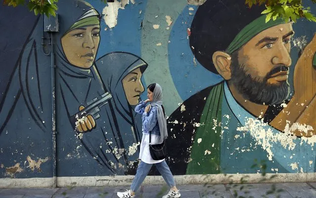 An Iranian woman walks past a mural in “Palestine Square”, in Tehran, Iran, 17 October 2023. Iranian supreme leader Ayatollah Ali Khamenei on 17 October 2023 warned Israel to stop the attack on Gaza, saying 'if the crimes continue, no one will be able to stop the Muslims and the Resistance forces'. Thousands of Israelis and Palestinians have died since the militant group Hamas launched an unprecedented attack on Israel from the Gaza Strip on 07 October 2023, leading to Israeli retaliation strikes on the Palestinian enclave. (Photo by Abedin Taherkenareh/EPA/EFE)