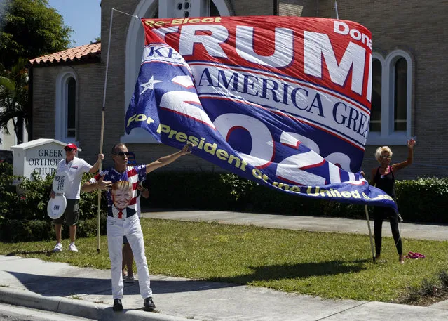 Supporters of President Donald Trump are seen from the media van in the motorcade accompanying the president in West Palm Beach, Fla., Saturday, March 23, 2019, en route to Mar-a-Lago in Palm Beach, Fla. (Photo by Carolyn Kaster/AP Photo)