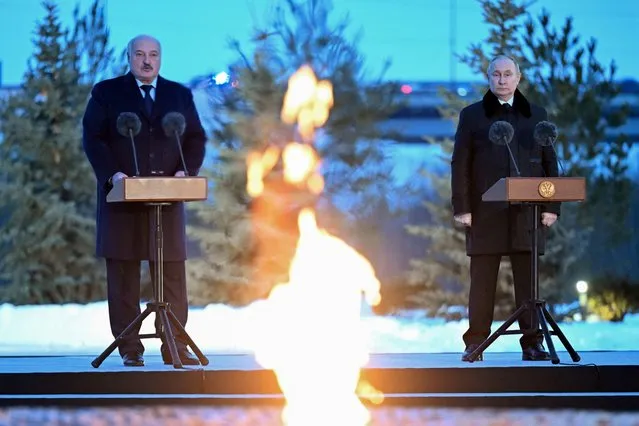 In this pool photograph distributed by Russian state agency Sputnik, Russia's President Vladimir Putin (R) and Belarus' President Alexander Lukashenko (L) address the audience at the opening ceremony of a monument to civilians killed during World War Two, near the village of Zaytsevo, Leningrad region, on January 27, 2024, as part of events marking the 80th anniversary of the liberation of Leningrad from Nazi blockade during WWII. (Photo by Dmitry Azarov/Pool via AFP Photo)