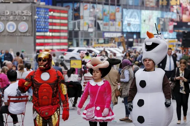 Workers dressed as fictional characters walk through Times Square during a warm weather spell in New York March 10, 2016. (Photo by Lucas Jackson/Reuters)