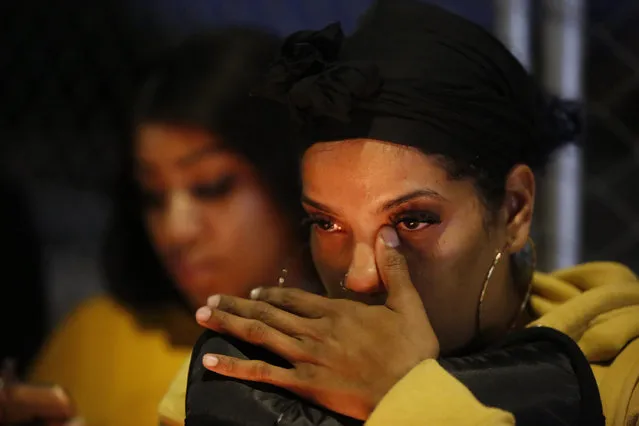 Jasmine Gurtrick, 26, from Compton, Calif., reacts to the fatal shooting of rapper Nipsey Hussle across from his clothing store in Los Angeles, Sunday, March 31, 2019. (Photo by Damian Dovarganes/AP Photo)
