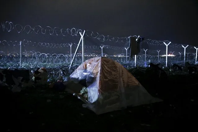 A tent is set next to the Greek-Macedonian border fence at a makeshift camp near the village of Idomeni, Greece March 16, 2016. (Photo by Alkis Konstantinidis/Reuters)